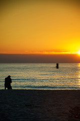 Photographer on the beach at sunset