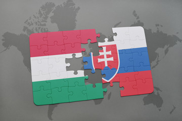 puzzle with the national flag of hungary and slovakia on a world map background. © luzitanija