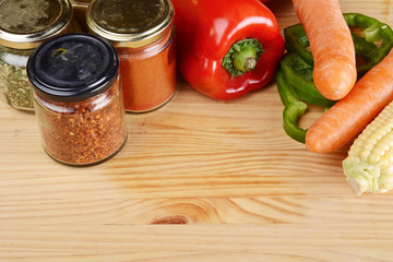 Vegetables and seasonings on wooden table.
