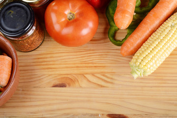 Vegetables and seasonings on wooden table.