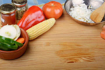 Vegetables and seasonings on wooden table.