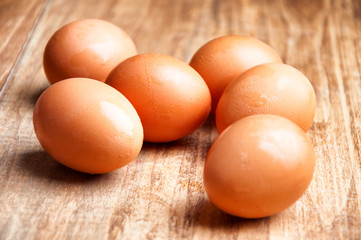 The image of eggs on a wooden table.