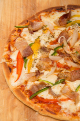 bacon vegetable pizza on wood