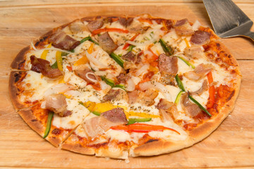 bacon vegetable pizza on wood