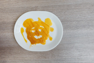 Pancakes with smile on wood background .