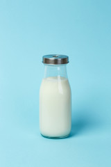 Fresh bottle of milk over blue background
