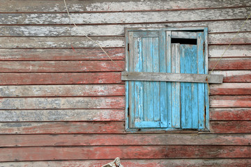 Naklejka na ściany i meble Old blue window of old wooden house wall