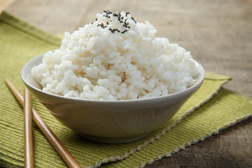 A bowl of rice on a fabric mat
