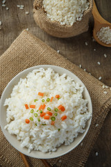 Cooked rice with chopsticks on a sack