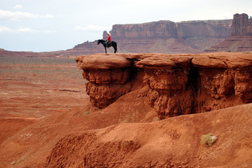 Man riding a horse at John Ford's point, Monument Valley