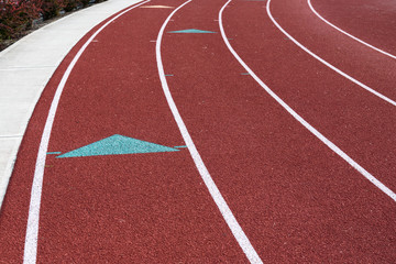 Fototapeta premium Closeup slice of a red school running track 