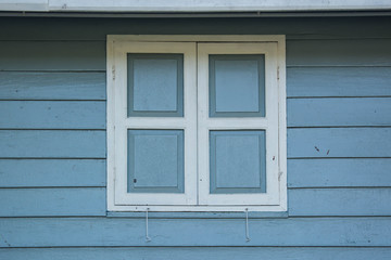 window closed with wooden exterior shutters