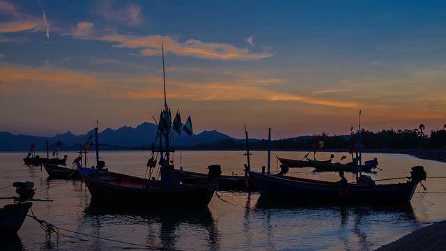 4k timelapse, group of fishing boat anchored at Pranburi beach in Thailand, day to night wide-angle view (UHD, ultra high definition, 4096x2304)
