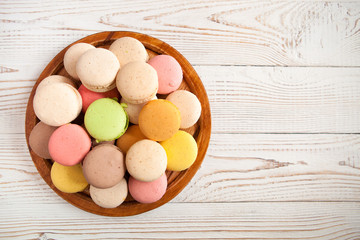 Colorful macaroons on white vintage table, with copy space