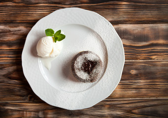Warm cut chocolate fondant with ice cream and cinnamon. Tasty fr
