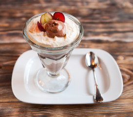 Sweet dessert - chocolate and vanilla pudding in glasses served