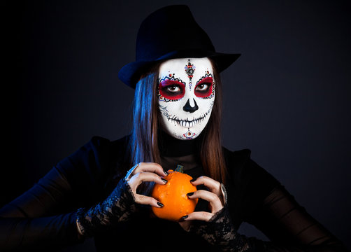 Sugar skull girl with pumpkin