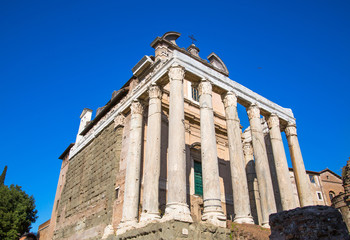 Fototapeta na wymiar ROME, Ruins of old temple at Roman's forum against of blue sky