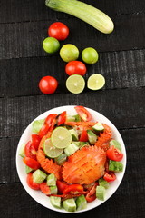 Top view-Crab and vegetables on dark background, 