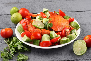 Summer salad with seafood on gray  background.