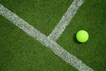 Tuinposter tennis ball near the line on tennis grass court good for backgro © kireewongfoto