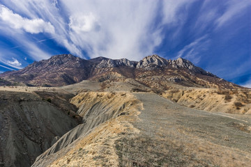 mountainous terrain under the blue sky with clouds