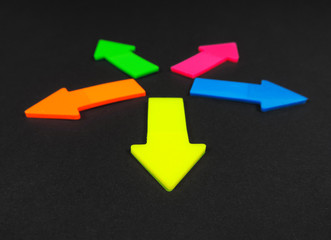 Neon colored arrows, isolated on black background