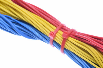 Bunch of colorful electrical cables with cable ties isolated on white background