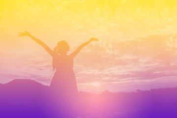 Fototapeta na wymiar Young woman enjoying beautiful sunset.