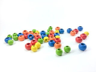 Colorful wooden beads isolated on white background.