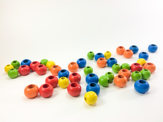 Colorful wooden beads isolated on white background.