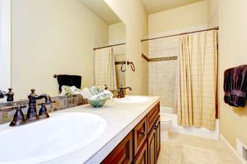 Beige tone bathroom interior with tile wall trim.