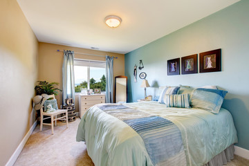 Fototapeta premium Bedroom interior in beige and blue tones. Also blue curtains