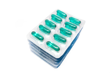 green soft gel capsules pills in blister pack