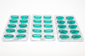 green soft gel capsules pills in blister pack