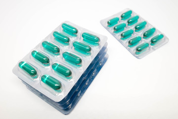green soft gel capsules pills in blister pack