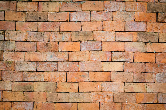 Aged red brick wall close up for background.