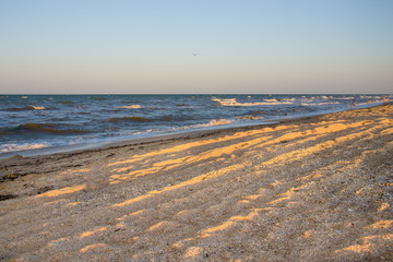 sea, waves, sandy beach and sunset