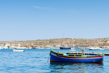 Naklejka na ściany i meble Traditional Maltese fishing boat, St Thomas Bay, Marsascala, Mal