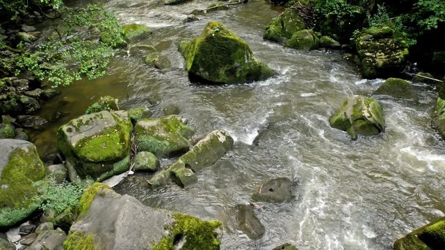 Aerial of a wild river with weathered stones
