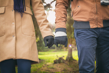 Young couple holding hands in the park.