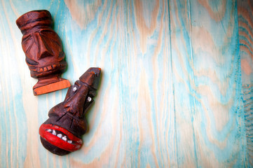 Handmade carved wooden figures on wooden background
