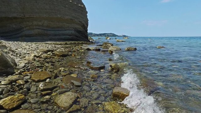 Coastline area near old city Piran and Strunjan, nice place for swimming with St. George's Parish Church view. Summer day, clear water in the sea and blue sky. Slovenian Istria, Slovenia, Europe.