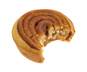 Bitten pecan sweet roll on a white background.