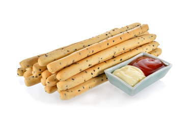 pile of crispy bread stick with black sasame, tomato sauce and m