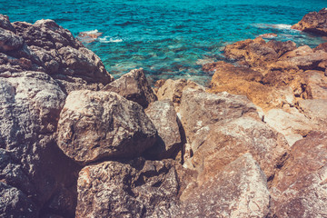 Large worn down boulders in foreground near ocean