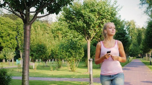 Young fitness woman running in a beautiful well-maintained park in a prestigious area of the city