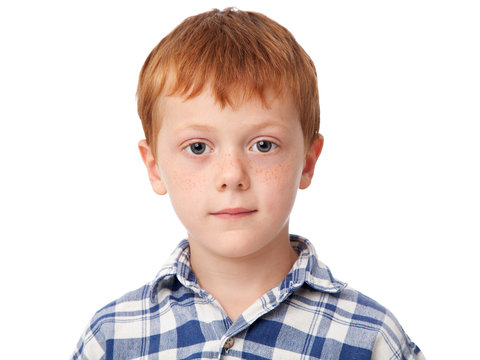 Close up face of a smiling ginger boy isolated on white background