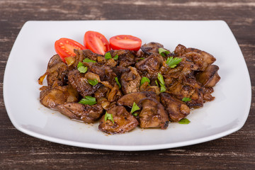 Chicken livers in a creamy sauce with onion on white plate