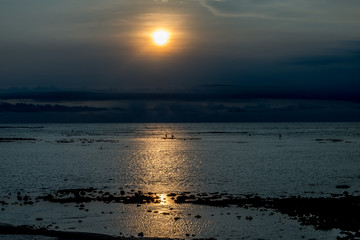 Sunset in Bali with fishermen